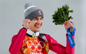 Kamil Stoch of Poland celebrates a rare Olympic ski jumping double. (GEPA/Andreas Pranter)